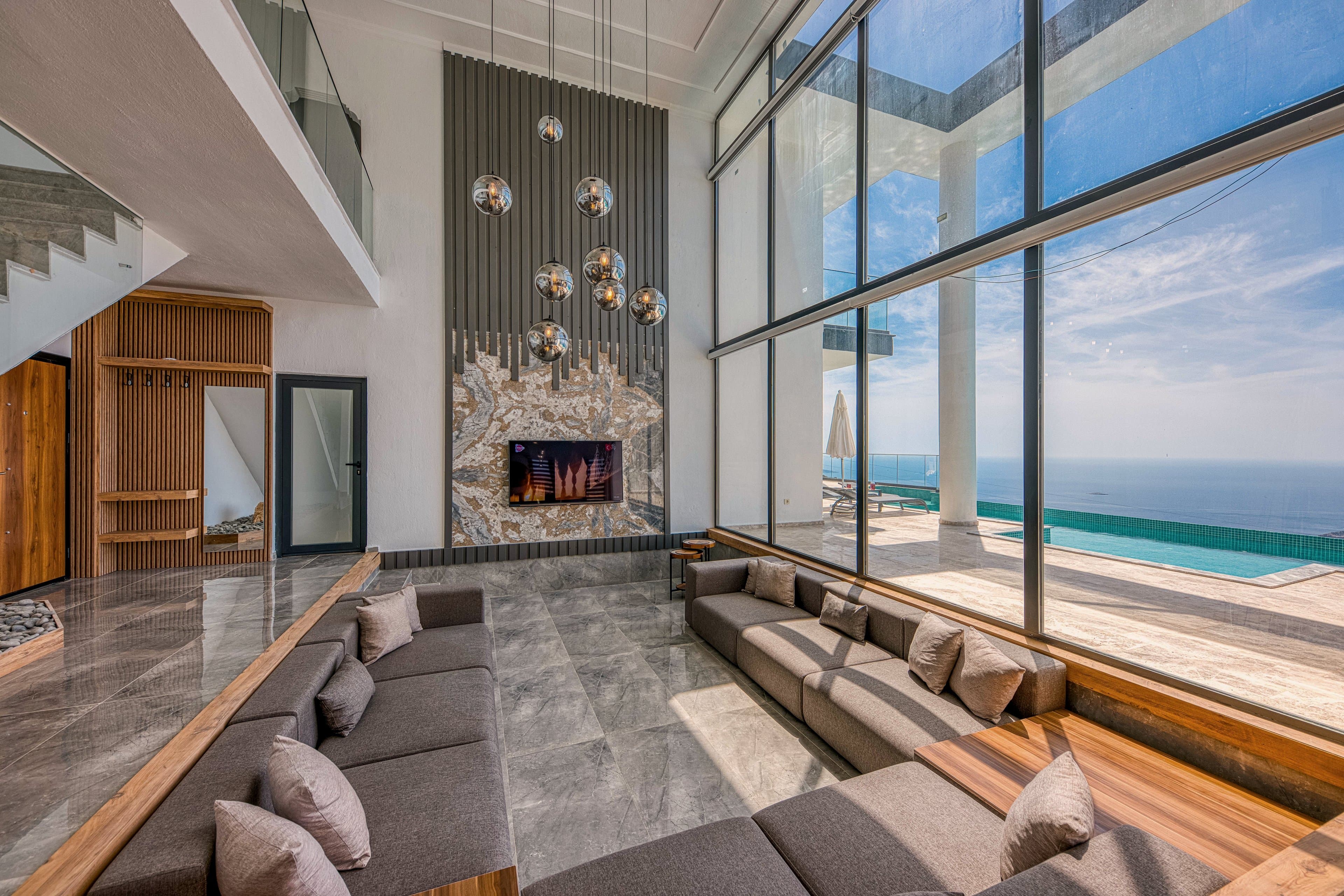 A stone living room, fully open to the sea