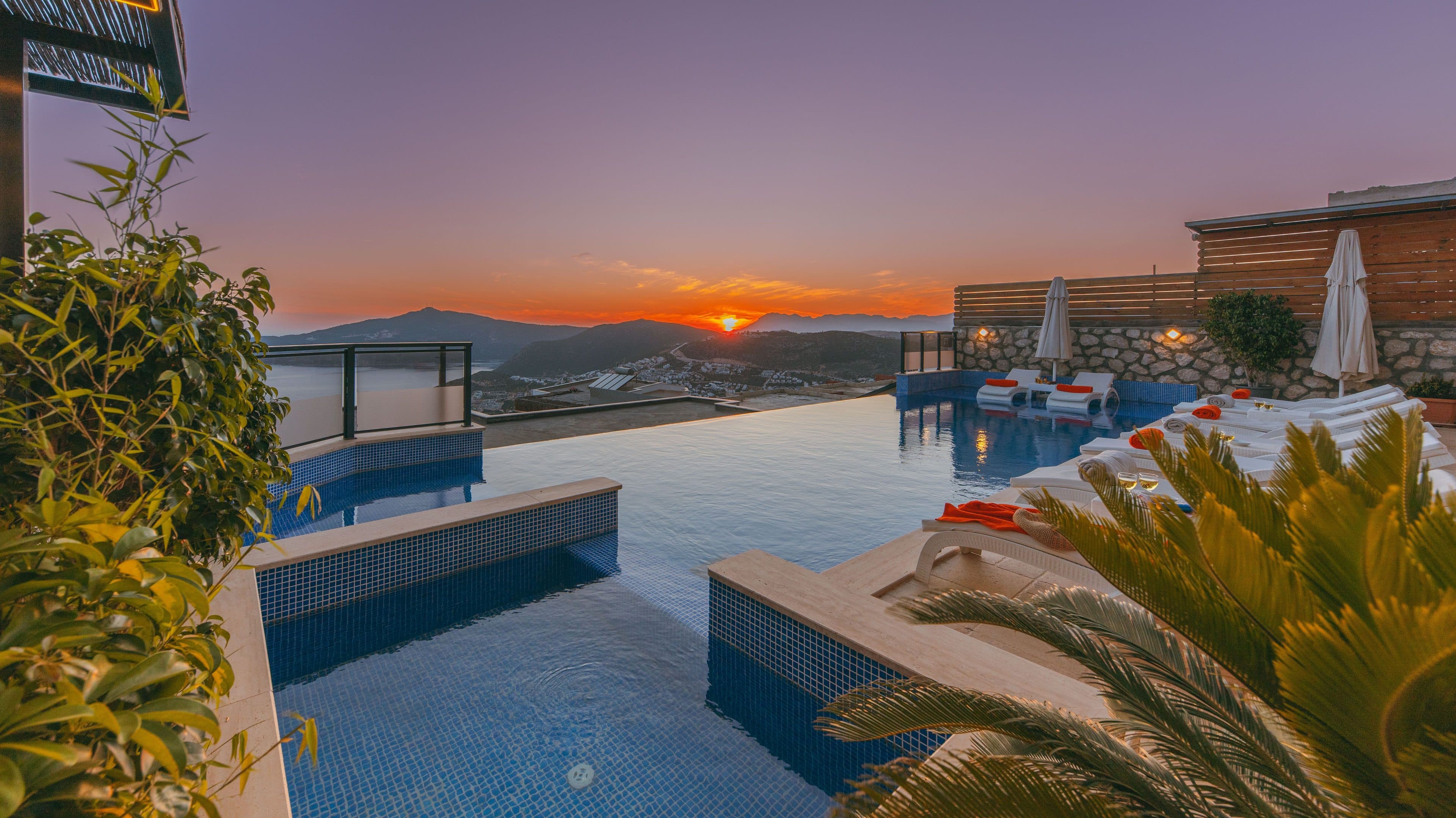 The saltwater pool at sunset, sea and hills beyond the edge